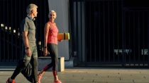 We love fitness. Side view of active middle-aged couple in sports clothing going to exercise together outdoors. Health and sport concept