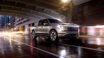 A pickup truck driving at night. A pickup truck driving at night.