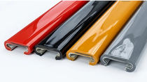Four curved plastic edge trim profiles in red, black, yellow, and gray displayed side by side.