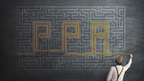 man try to solve a labyring on a chalkboard man try to solve a labyring on a chalkboard