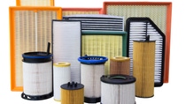 Assorted pleated industrial filter cartridges and panel filters in various sizes and frame colors. Assorted pleated industrial filter cartridges and panel filters in various sizes and frame colors.