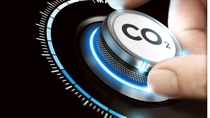 Close-up of a hand turning a dial labeled “CO₂”. Close-up of a hand turning a dial labeled “CO₂”.