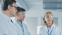 two men and two women scientists wearing safety goggles having a discussing   two men and two women scientists wearing safety goggles having a discussing