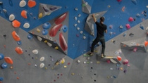 Man climbing a climbing wall in the gym Man climbing a climbing wall in the gym