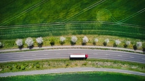 Drone shot direct above a truck moves along a single road. Drone shot direct above a truck moves along a single road.
