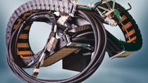Coiled cable assembly with connectors and electronic components on a light background.