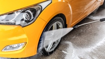 Pressure washer spraying car tires Pressure washer spraying car tires