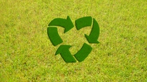 A heart shaped recycle symbol on the grass. A heart shaped recycle symbol on the grass.