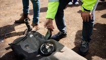 Image of worker identifying part of a car Image of worker identifying part of a car