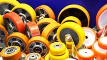 Group of Different Size Orange and Yellow Wheels Made of Cast Elastomers
