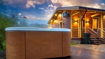 Hydromassage pool. Illuminated pool. Rest outside the city. Cottage with hydromassage pool. Hot tub in the background of the cottage. Outdoor hot tub. Hydromassage pool. Illuminated pool. Rest outside the city. Cottage with hydromassage pool. Hot tub in the background of the cottage. Outdoor hot tub.