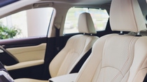 Car inside driver place. Interior of prestige modern car. Front seats with steering wheel dashboard. Beige cockpit with metal decoration panoramic roof on isolated white background Car inside driver place. Interior of prestige modern car. Front seats with steering wheel dashboard. Beige cockpit with metal decoration panoramic roof on isolated white background