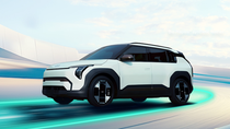 KIA EV3 is driving on a sleek, illuminated test track with a modern architectural backdrop and a bright sky. KIA EV3 is driving on a sleek, illuminated test track with a modern architectural backdrop and a bright sky.
