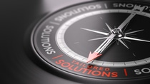 3D illustration of a compass over black background with the text tailored solutions written in red. Made-to-measure services concept. 