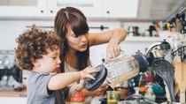 Mother and her little son preparing healthy smoothie