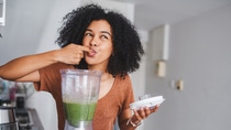 Shot of a young woman making a healthy smoothie at home Shot of a young woman making a healthy smoothie at home