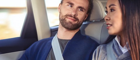 Um homem e uma mulher sentados juntos em um carro, sorrindo enquanto dirigem. Um homem e uma mulher sentados juntos em um carro, sorrindo enquanto dirigem.