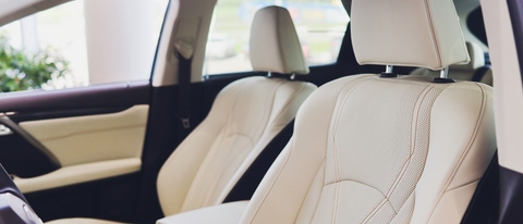 Car inside driver place. Interior of prestige modern car. Front seats with steering wheel dashboard. Beige cockpit with metal decoration panoramic roof on isolated white background