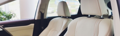 Car inside driver place. Interior of prestige modern car. Front seats with steering wheel dashboard. Beige cockpit with metal decoration panoramic roof on isolated white background
