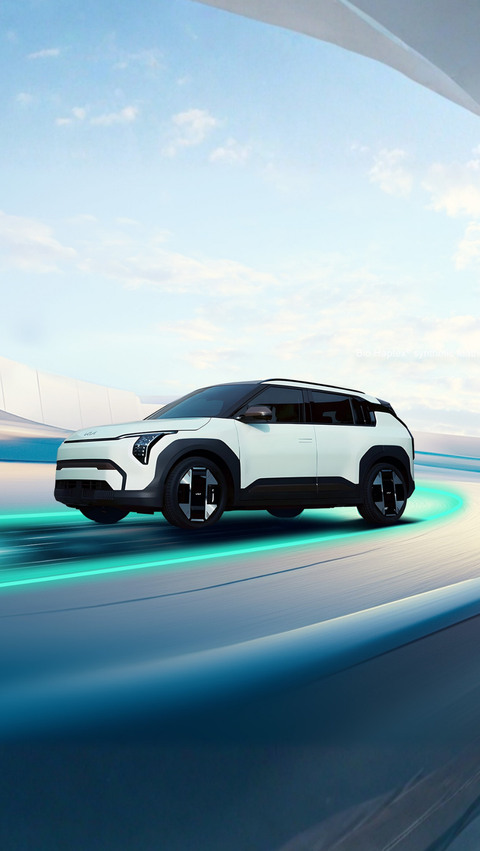 The KIA EV3 is driving on a fictional road.