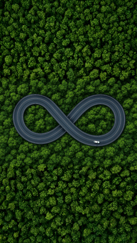 A car driving on a highway in the shape of an infinity loop, with a forest seen from above in the background.