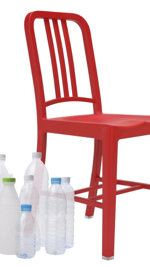 Empty water bottles beside a red chair 