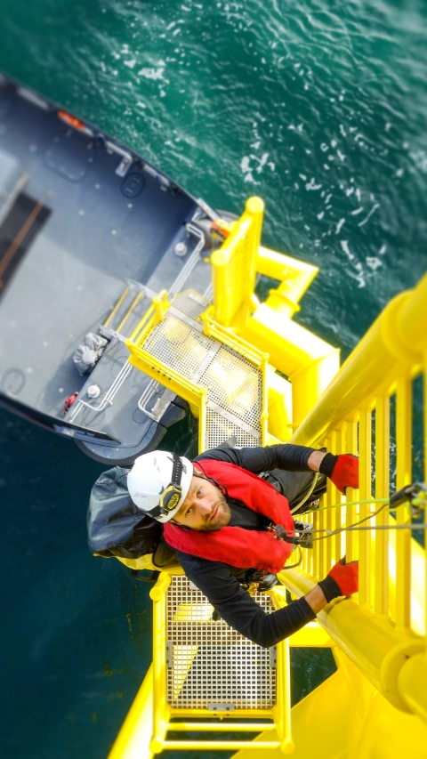 Wind-turbine, offshore, worker, climbing, high up, boat, sea