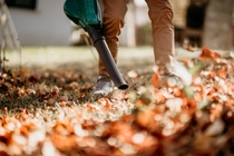 Gardener using leaf blower, vacuum and working in garden Gardener using leaf blower, vacuum and working in garden