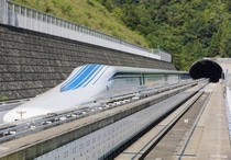 The L0 (L zero) series magnetic-levitation train, developed by Central Japan Railway Co., sits parked on a test track at the control center before a trial run in Tsuru City, Yamanashi Prefecture, Japan, on Thursday, Aug. 29, 2013. Japan resumed trial runs for the world's fastest magnetic-levitation train that will complement the Shinkansen bullet-train network when ready in 2027. Photographer: Yuriko Nakao/Bloomberg via Getty Images