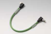 Green industrial cable with connectors at both ends on a light gray background.